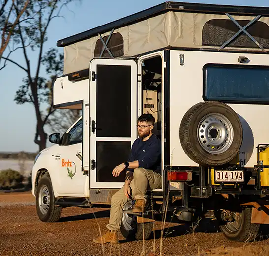 4WD Maverick Camper with a man sitting at the back door