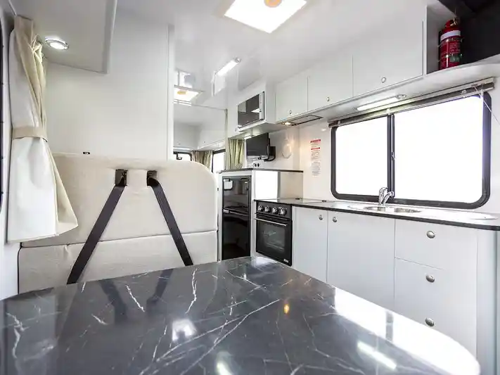 Cheapa 6 Berth Interior featuring middle dinette and kitchen
